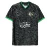 Black Syria national football jersey with green trim, floral pattern design, Arabic calligraphy, Syria map emblem, and number 24 on the back – men's XL size.